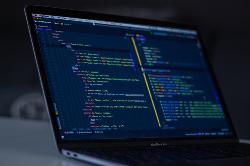 WordPress vs Blogger comparison showing laptop screens with both platforms