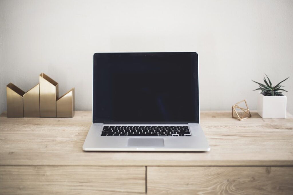 Blog photography setup with camera and laptop on desk for UK blogger tips