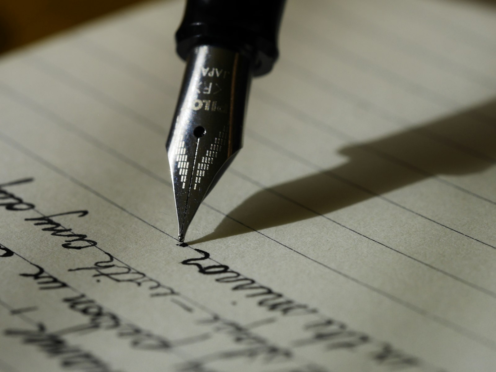 Person writing in a notebook with a pen, planning blog introduction techniques for UK bloggers