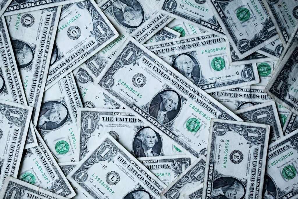 UK blogger working on laptop with money and growth charts showing blog monetisation