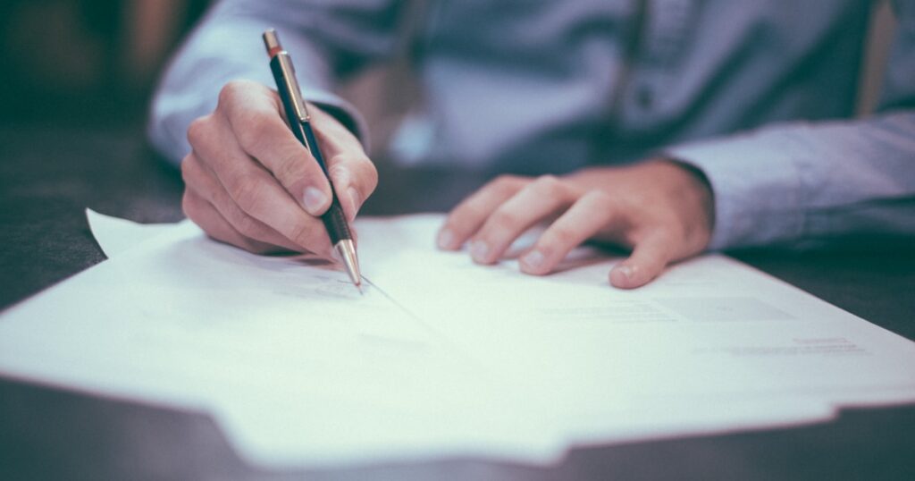 Documents and contracts on a desk representing UK GDPR compliance for bloggers