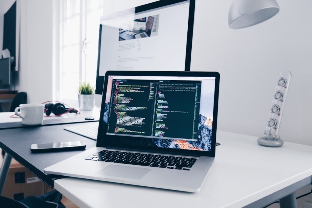 Collection of blogging tools including a laptop, notebook, smartphone and coffee on a desk